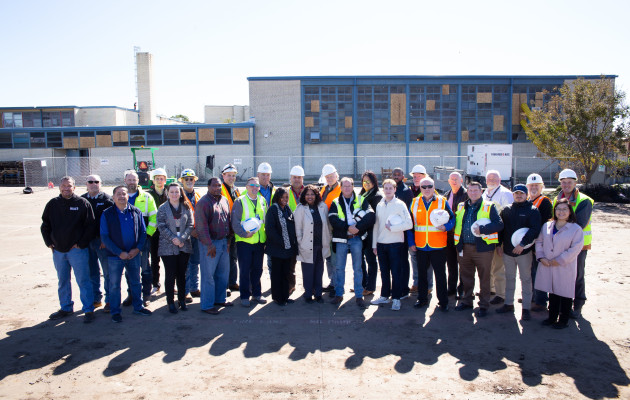 Group of Adjusters Standing Near Damaged School