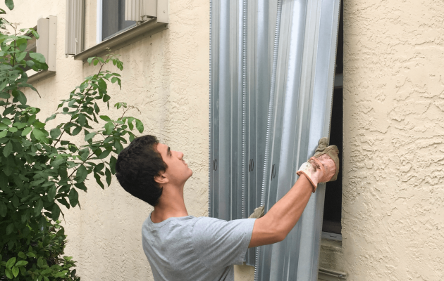 Young Man in Grey Shirt Boarding Windows to Home